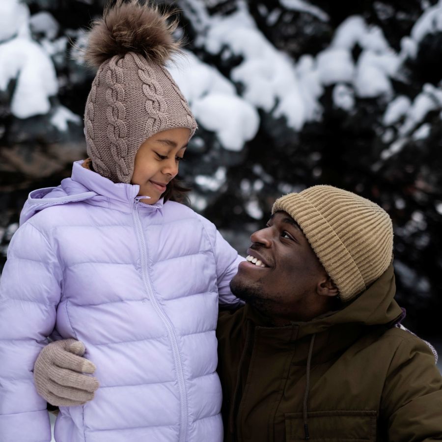 Young Girl Enjoying Winter Day Outdoors With Her Father