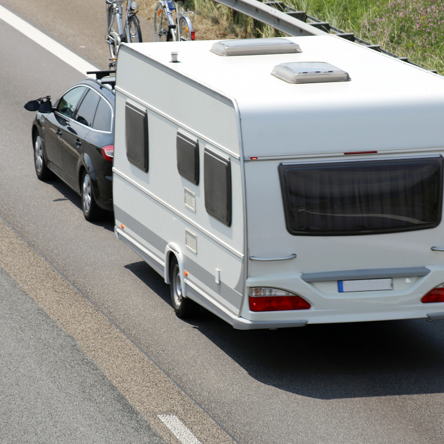 Car With Caravan On Motorway