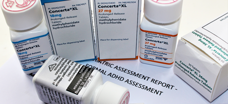 ADHD medication (Concerta) boxes and pill containers.